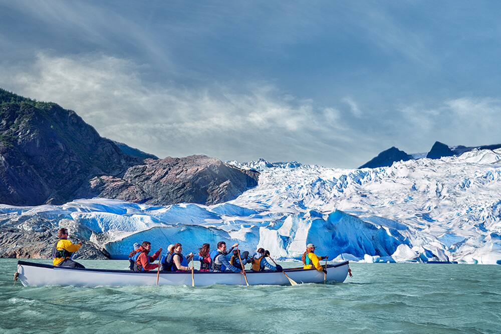 People rowing canoe in Alaskan waters