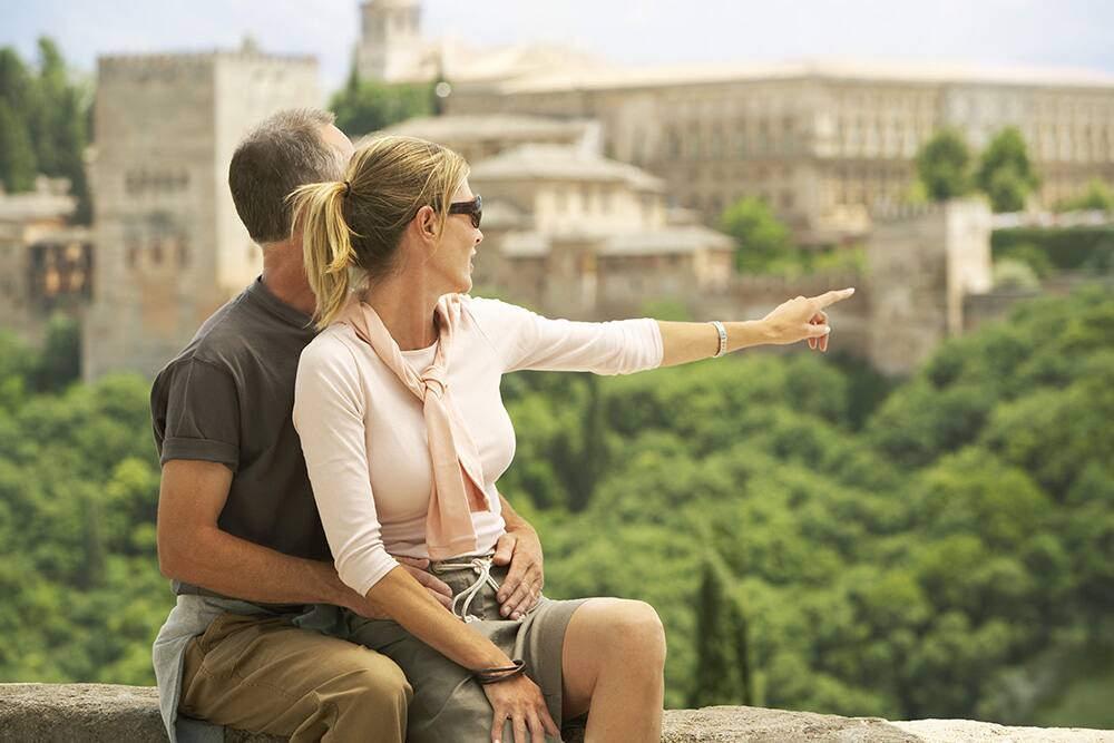 Tourist couple enjoying the view of Alhambra, Granada, Spain