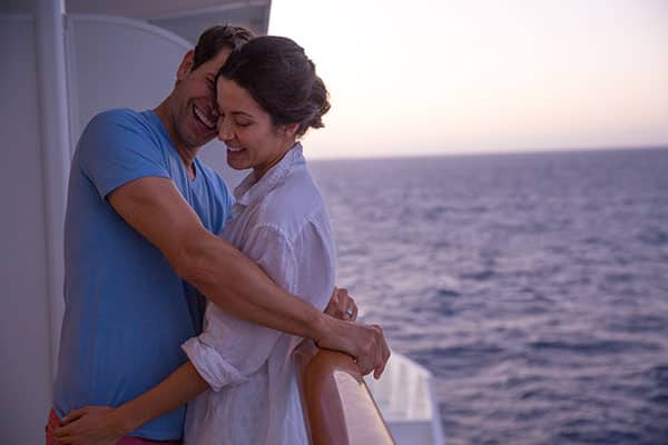 Couple embracing on their balcony