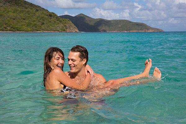 Couple playing in the blue ocean