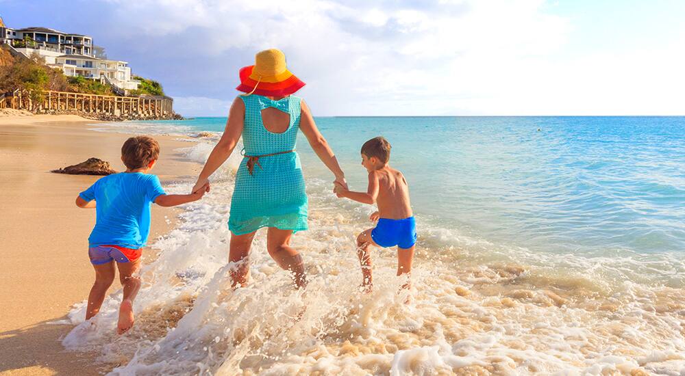 Family playing in Caribbean beach